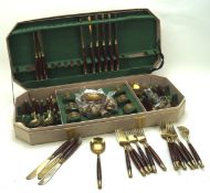 A vintage canteen of Thai Bronze cutlery, most with wooden handles, to include forks, knives,