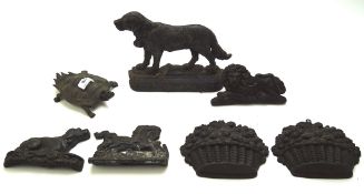 An assortment of vintage doorstops and similar metalware,