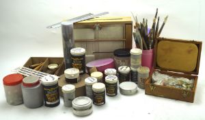 A variety of artist's equipment, including brushes, paint sets, an easel,