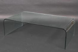 A 20th century curved glass coffee table,