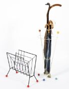 A mid century magazine rack together with an umbrella stand in the manner of Alexander Calder.