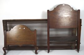 A late 19th/early 20th century mahogany single bed with shaped bed ends,