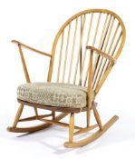 An Ercol style hoop backed rocking chair. with upholstered seat.