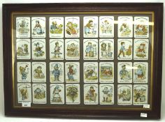 A 'Happy Families' collection of cards, framed and glazed,