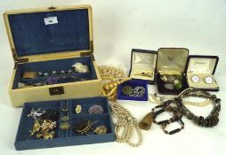 A variety of jewellery, including an ivory brooch carved as a rose,