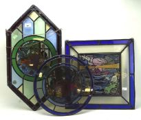A group of three 20th century stained glass panels, with two depicting fruit still lifes,