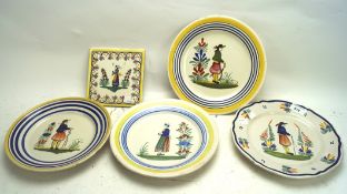 Four French pottery plates and a title, the tile from Desvres and depicting a woman,