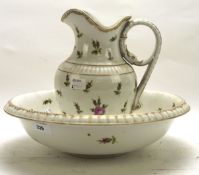 A 19th century porcelain wash jug and basin, each with floral design and gilt rims,