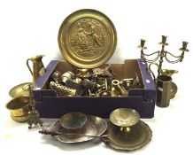 A large collection of brassware, including assorted candlesticks, a circular charger, vases,