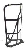 A metal framed saddle rack, painted black,