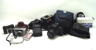 An assortment of vintage cameras, including a Kodak 'Brownie', Canon 'Spirit',