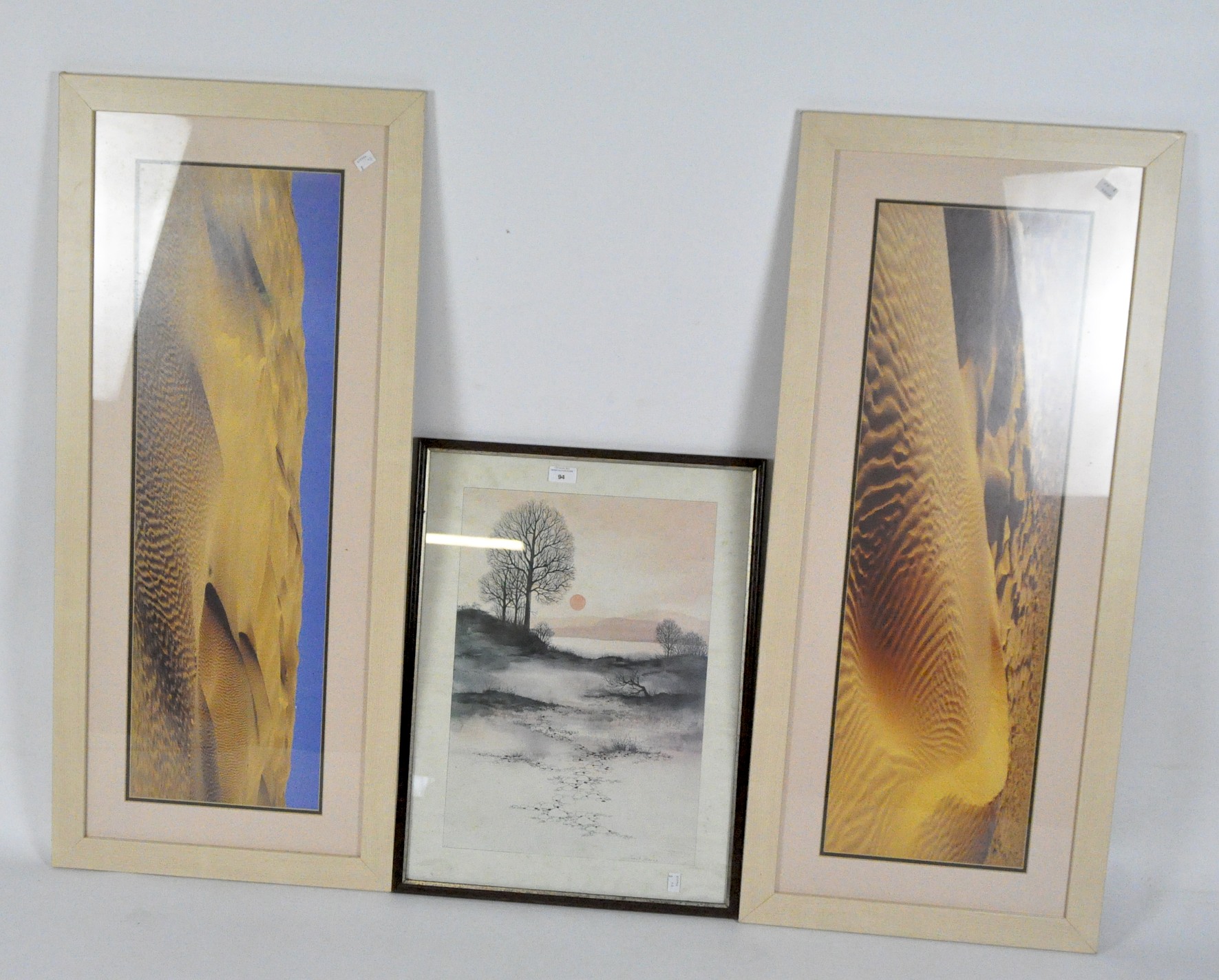 Two modern photographic prints of sand dunes and a print of a rural sunset, all framed and glazed,