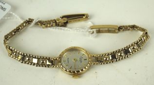 A vintage 9ct gold ladies wristwatch by Everite, the silvered dial with gilt batons denoting hours,
