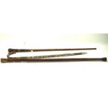 Three 20th century walking canes, one mounted with a stone handle,