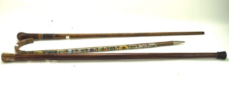 Three 20th century walking canes, one mounted with a stone handle,