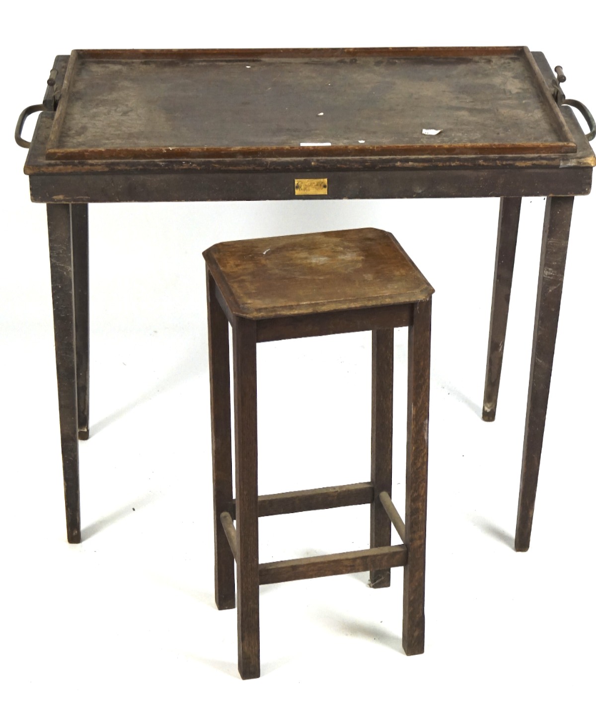 An early 20th century mahogany butlers tray on folding legs together with an oak occasional table