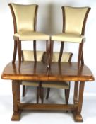 An Art Deco burr walnut veneer extending dining table, with four dining chairs,