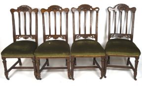 A set of four mid-century oak chairs, with shaped top and carved details,