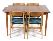 A teak extending dining table together with a set of four ply and teak framed dining chairs