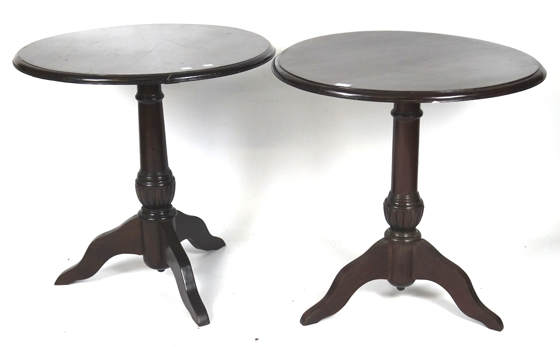 Two modern stained wooden tables, of circular form, raised upon tripod supports,
