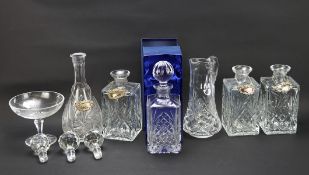 A collection of 20th century glassware, including a set of three decanters and one other, a dish,