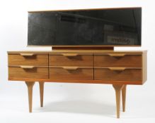 A mid century teak veneered dressing table with mirrored back,