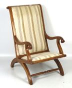 A 20th century upholstered wooden armchair, with scrolling arms and legs,