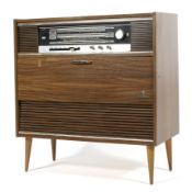 A Grundig multi stereo radiogram in veneered wooden cabinet on circular tapering legs.