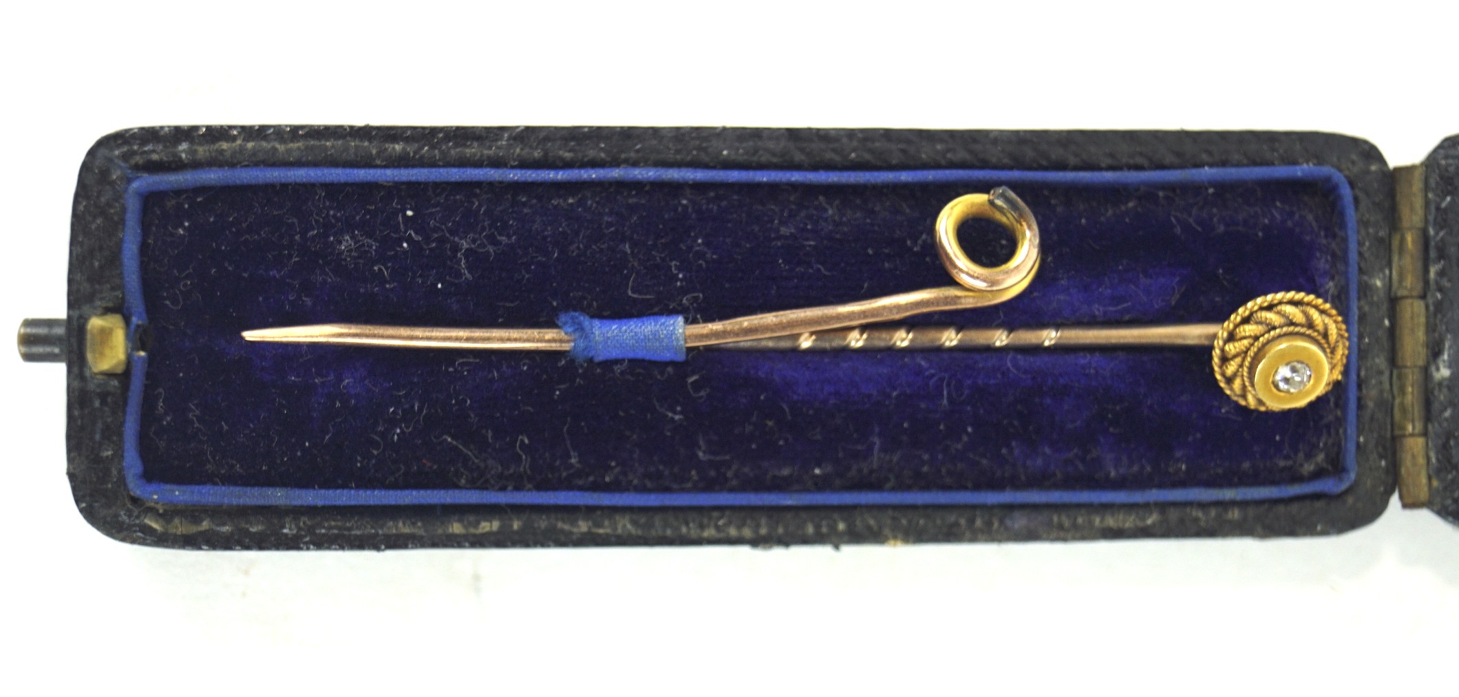 A 9ct gold pin and a yellow metal diamond set tie pin, the diamond set in a rope twist mount,