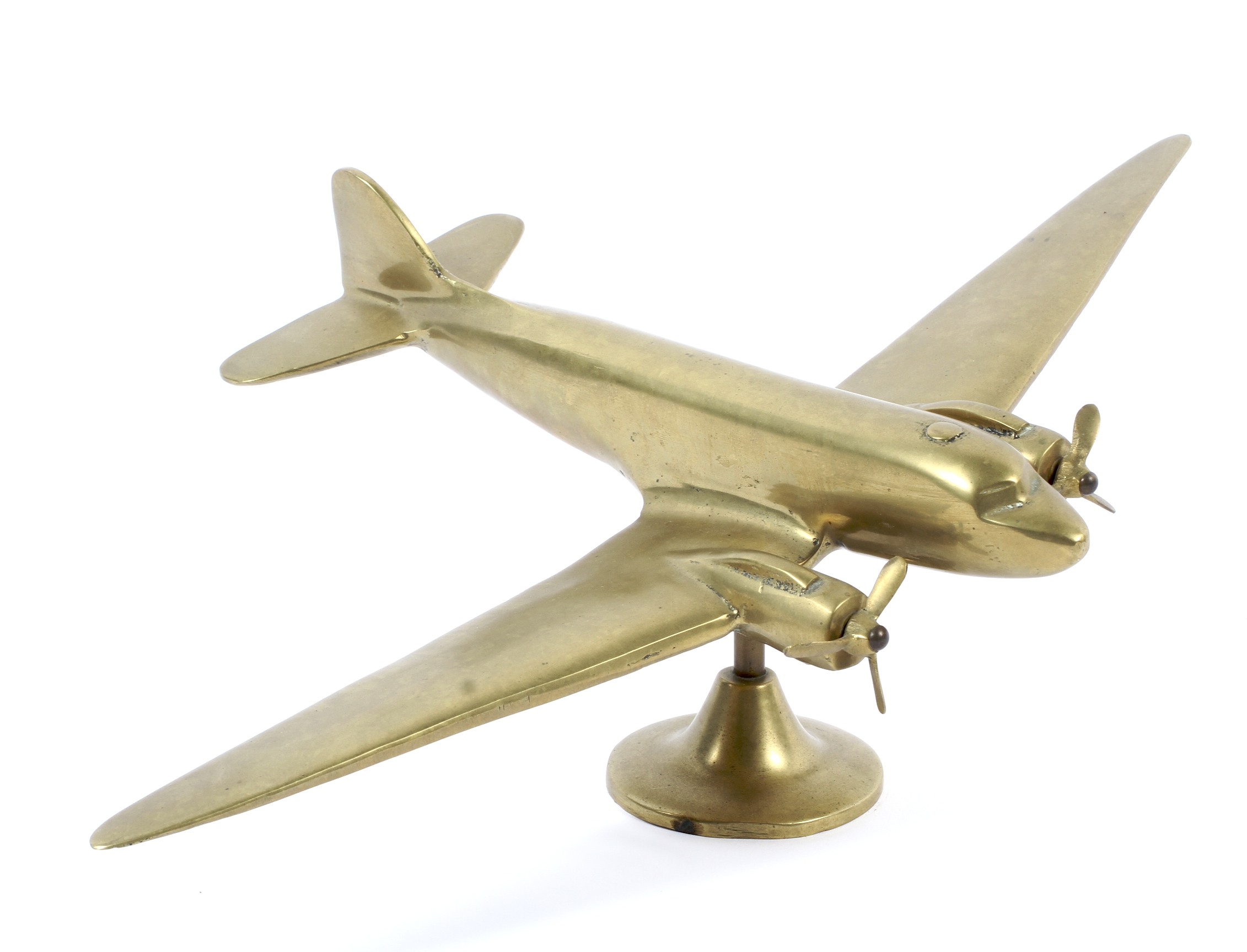 A brass retro model of a plane,