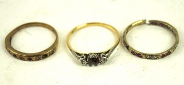 A 9ct gold gem set half eternity ring and two yellow metal rings