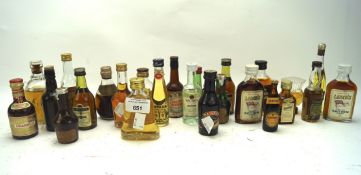 A quantity of alcohol miniatures, some opened, including Crema le bananas, Lamb's Navy Rum,