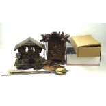 A collection of cuckoo clocks and related parts, to include two wooden casings,