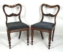 A pair of Victorian dining chairs, the mahogany frames with curved backs and carved details,