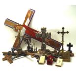 A selection of wooden and metal religious crosses and crucifixes, most being table top examples,
