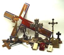 A selection of wooden and metal religious crosses and crucifixes, most being table top examples,