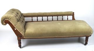 A Victorian chaise lounge, with a scroll end and backrest covered in buttoned,