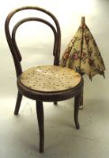 A child's bentwood cafe chair and a parasol, the first with pierced wood seat, height 64cm,