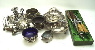 A collection of silver plate and metalware, including dishes, flatware, a candlestick,