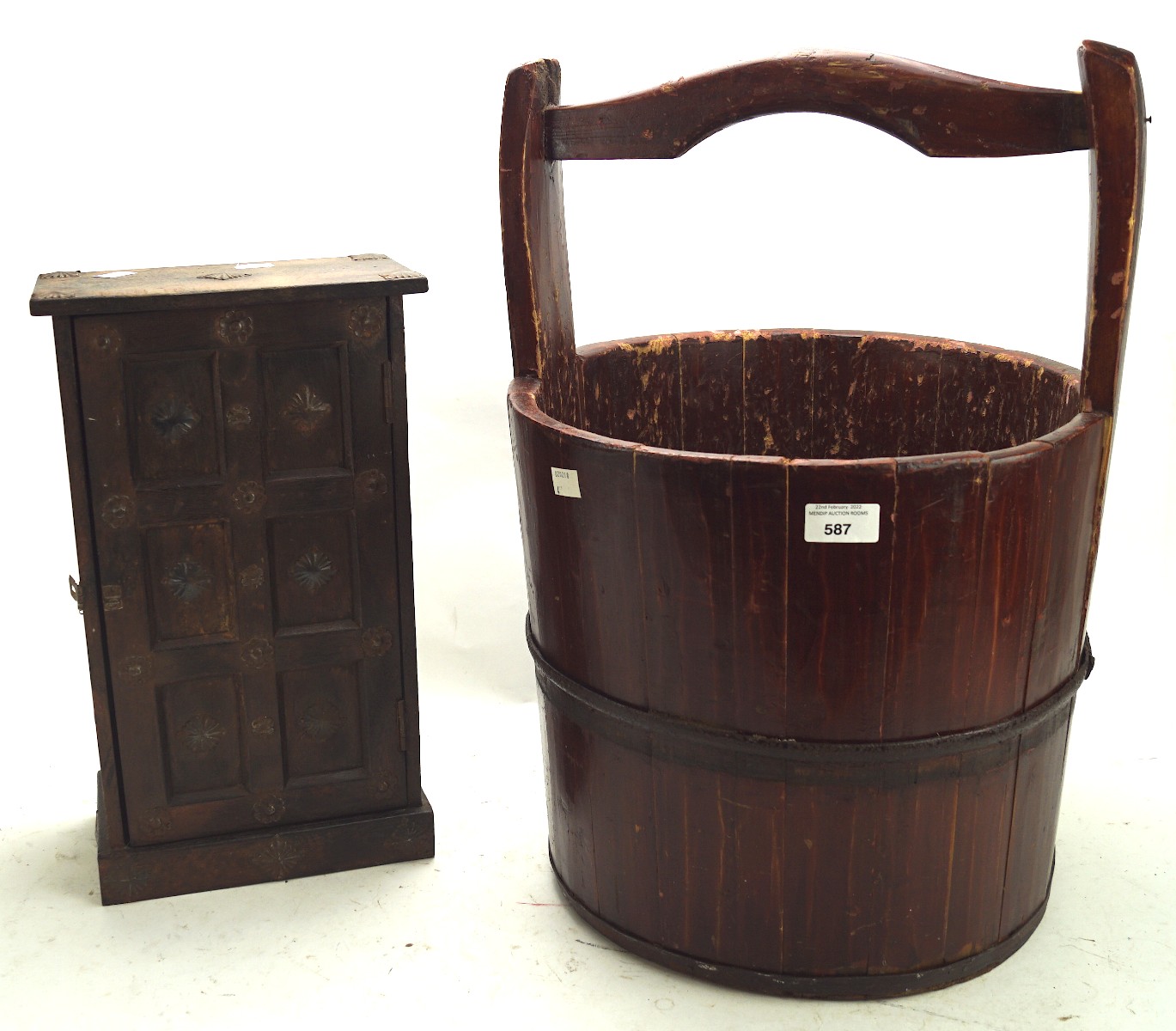 A vintage wooden bucket fixed with two metal hoops, and a table top cabinet.