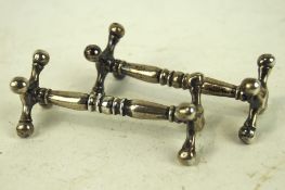 A pair of silver knife rests by the Atkin Brothers, hallmarked Sheffield 1899,