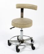 An industrial machinist's swivel chair on a chromed metal five point circular base