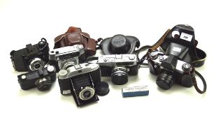 A collection of vintage cameras, including a Flashmaster, a National Miniature,