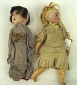 Two vintage dolls, one ceramic with glass eyes, both with original clothing,