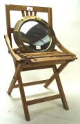 A 20th century child's wooden chair and a wall mirror, the folding chair with multiple slats,