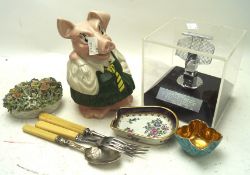 An assortment of collectables, including a Nat west pig, flatware,