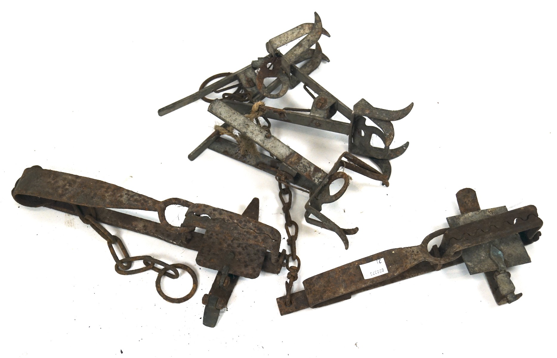A collection of vintage animal traps, all cast metal,
