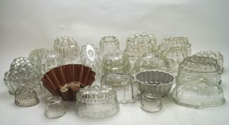 A collection of assorted vintage and modern glass jelly moulds,