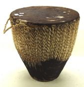 A large tribal double ended skin drum, with weaved decorated to the side,