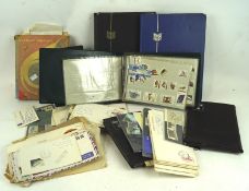 A collection of stamp albums, the albums containing a variety of stamps from a range of countries,